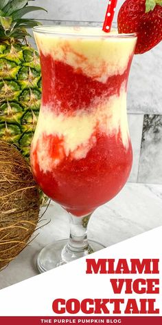 a red and white drink in a glass next to a pineapple