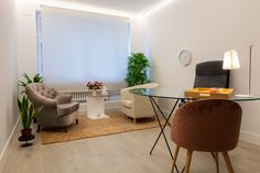 a living room filled with furniture and a glass table