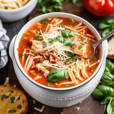 a white bowl filled with pasta soup and garnished with parmesan cheese