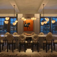 a dining room table with chairs and lights