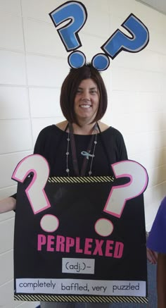 a woman holding a sign that says perplexed with question marks above her head