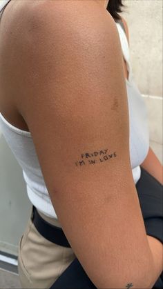 the back of a woman's arm with writing on it that says friday i'm in love