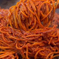 spaghetti is being cooked in a pan on the stove