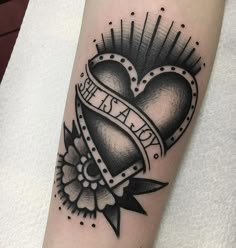 a black and white heart tattoo on the arm