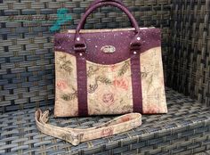 a purse sitting on top of a chair next to a handbag with flowers painted on it