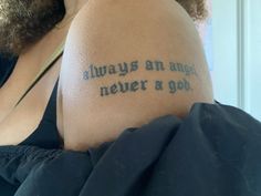 a woman with a tattoo on her back saying, always an angel never a god