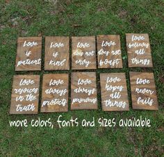 wooden signs with words written on them sitting in the grass