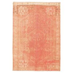 an orange and beige rug with ornate designs on the front, in two different colors