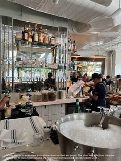 people in a kitchen preparing food and drinks