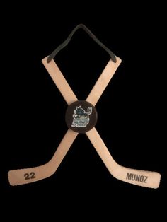 two wooden hockey sticks with the number 22 on each one and an embroidered minnesota logo