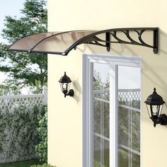 an awning over a patio door with two lights on the outside and one light on the inside