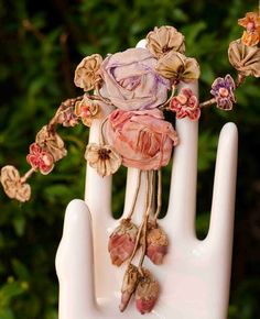 a hand with flowers on it is holding something