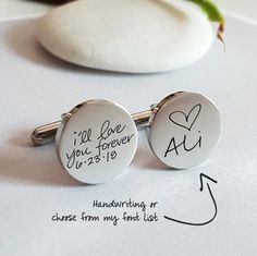 two personalized cufflinks with handwriting on them