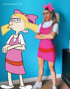 a woman standing next to a cartoon character