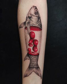 a fish in a bottle tattoo on the left forearm and leg, with red balls coming out of it