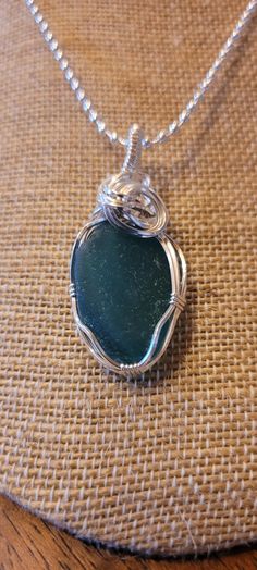 This piece of Maine sea glass is a gorgeous teal blue and handcrafted in sterling silver. This color isn't found very often. The pendant comes with a 24" silver plated chain (as shown) and gift box. Shipping is included. Silver Wire Wrapped Necklace With Recycled Glass, Sterling Silber, Teal Blue, Sea Glass, Jewelry Necklace Pendant, Silver Plate, Maine, Silver Plated, Pendant Necklaces