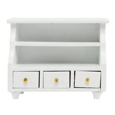 a white shelf with three drawers and two gold knobs on the bottom, against a white background