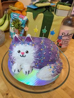 a birthday cake decorated to look like a cat with sprinkles on it