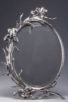 an ornate silver plate with flowers on it