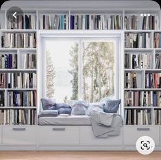 a window seat in front of a bookcase filled with lots of books and pillows