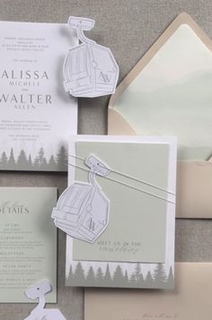 the wedding stationery is laid out on top of each other