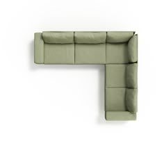 a green couch sitting on top of a white wall