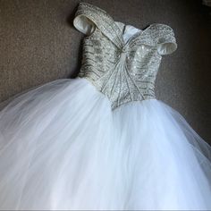 This Is A Fantastic White Very Full Netting Ball Gown With A White Beaded Bodice Of Pearl And Silver Beads . It’s Off The Shoulders , Has A Zipper In The Back And Is In Very Good Party Ready Condition, No Stains Or Missing Beads. It Literally Could Be Worn By The Queen, Stunningly Beautiful, Pit To Pit Is 19in , Waist Is 17in Overall Length Is About 58in White Sequined Ball Gown For Wedding, Elegant Floor-length Pageant Dress For Wedding, White Sequined Wedding Ball Gown, Elegant Floor-length Wedding Pageant Dress, White Ball Gown Evening Dress, White Sequined Ball Gown For Party, White Ball Gown Evening Dress For Debutante Ball, White Sequined Ball Gown, White Sequin Gown For Debutante Ball