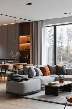 a living room filled with furniture and large windows