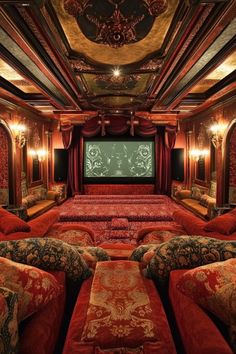 a theater with red couches and pillows