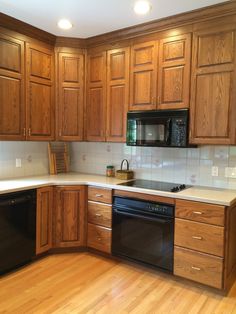 a kitchen with wooden cabinets and black appliances