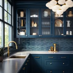 a kitchen with blue cabinets and gold accents