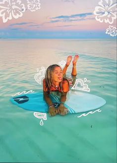 a woman laying on top of a surfboard in the ocean