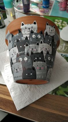 a pot with cats on it sitting on top of a table