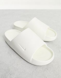 Shoes by Nike Slide into the szn Slip-on style Branded strap Open toe Chunky sole Slip On Sandals, Nike White Sandals For Spring, Nike White Sandals With Removable Insole, Comfortable White Slides With Flat Heel, Comfortable White Flat Heel Slides, Nike Calm Slides Outfit, White Flat Heel Slides For Spring, White Slides With Removable Insole For Spring, Nike White Slide Sandals