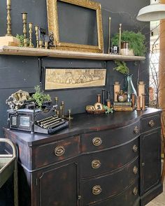 an old fashioned desk with a vintage typewriter on it's top and shelves