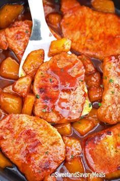 some meat and potatoes are being cooked in a slow cooker with a ladle