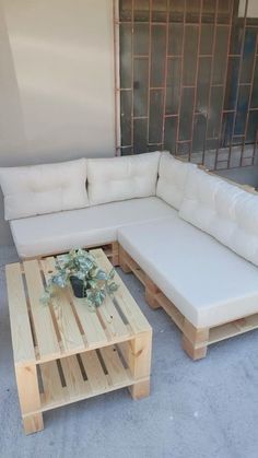 a white couch sitting next to a wooden table