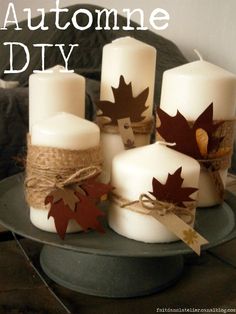 four candles are sitting on a plate with some fall leaves tied to them and the words, autumn diy