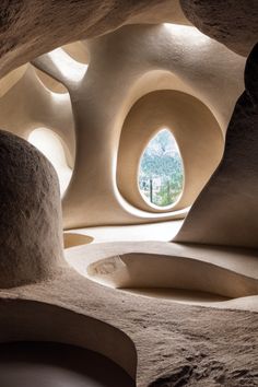 the inside of a cave with an oval window in it's center and rock formations on either side