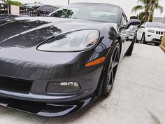 a black sports car parked in front of a house