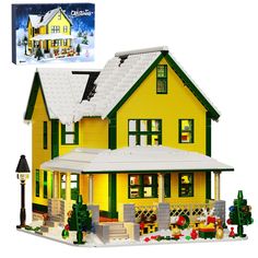 a yellow house with snow on the roof and windows, in front of a white background