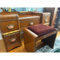 two wooden dressers with matching footstools and mirror in the background, one has a red velvet seat