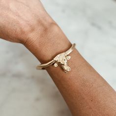 Buy in 14K Gold. Celebrate the spirit of strength, resilience, and heritage with our handcrafted Longhorn cuff. Click [here] to discover the full story behind this meaningful design in our blog. The SMALL cuff fits up to a 6.75" wrist.The MEDIUM cuff fits up to a 7.5" wrist. MIMOSA bracelets are slightly adjustable. The first time you put your new bracelet on, adjust it one time to a size that slips on and off comfortably. Our jewelry is solid cast metal, so repeated adjusting can cause it to br Texas Jewelry, Birthstone Bracelets, Birthstone Earring, Gold Studs, Birthstone Necklace, Stone Earrings, Birthstone Jewelry, Belt Buckles, Wearable Art