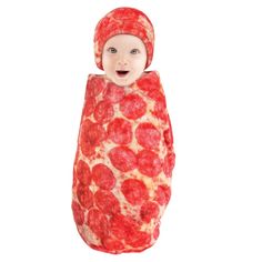 a baby dressed in a pepperoni pizza costume