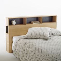 a bed with two bookshelves above it and a night stand on the side