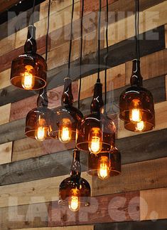 a bunch of light bulbs hanging from a wooden wall