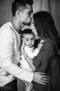 a man, woman and child kissing each other