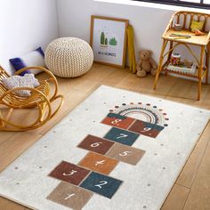 a child's room with a rocking chair, rug and toys on the floor