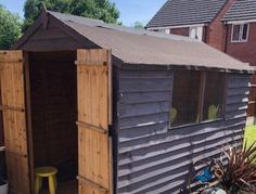 a small wooden shed sitting on top of a yard