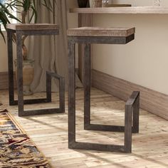 two wooden tables sitting next to each other on top of a hard wood floored floor